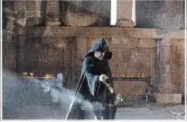  ??  ?? A priest burns incense at the Noravank Monastery, near Yeghegnadz­or, Armenia.