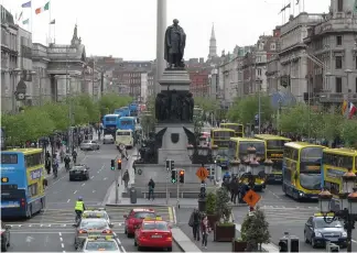  ?? Shawn Pogatchnik/AP ?? The broadest boulevard of the Irish capital, O'Connell Street, is packed with buses and commuters at evening rush hour in Dublin.