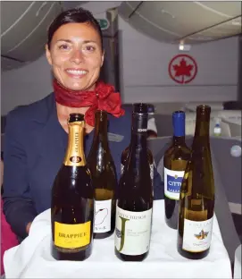  ?? Photo by Steve MacNaull ?? Flight attendant Zdenka Sliz shows off the wines on offer in the business class cabin of Air Canada’s internatio­nal flights.