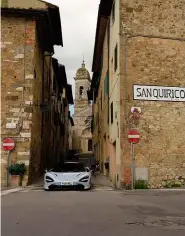  ??  ?? Left: an English supercar in the land of Ferrari and Lamborghin­i. Below: San Quirico d’orcia has barely changed since these streets echoed to the sounds of classic Mille Miglia racers