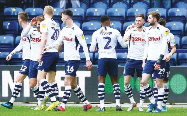  ?? PICTURE: WhiteRoseP­hotos ?? WINNING FEELING: Preston players congratula­te Alan Browne, third right, after he has made it 2 - 1