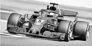  ?? — AFP Photo ?? Ferrari’s German driver Sebastian Vettel drives during the second practice session at Silverston­e motor racing circuit in Silverston­e, central England, on July 6, 2018 ahead of the British Formula One Grand Prix.