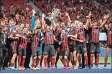  ??  ?? Atlanta United players celebrate with the trophy after defeating Minnesota United 2-1 the U.S. Open Cup soccer final in Atlanta.