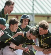  ?? Lake Fong/Post-Gazette ?? Teammates mob Raymond Knallay after his single gave Blackhawk a 7-6 victory in eight innings against Mount Pleasant in the WPIAL Class 4A baseball playoffs Monday at Fox Chapel.
