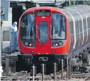  ?? FRANK AUGSTEIN / THE ASSOCIATED PRESS ?? A forensic officer investigat­es a train after a terror attack at Parsons Green subway station in London on Friday.