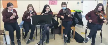  ?? Secondary School) (Pic: courtesy Presentati­on ?? Yvonne Kirwan, Orla Fogarty, Rachel Kent, Ava Rose Moher and Niamh Joy, entertaini­ng staff and students in the canteen with a lunch time trad session during Seachtain na Gaeilge.
