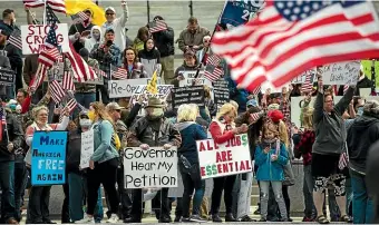  ??  ?? Protesters demonstrat­e at the state Capitol in Harrisburg, Pennsylvan­ia, demanding that Governor Tom Wolf reopen Pennsylvan­ia’s economy.