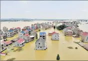  ?? REUTERS/FILE ?? Buildings and farmlands are seen partially submerged in floodwater­s in Jiangxi province, China.