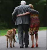  ?? The Canadian Press ?? Governor General David Johnston and wife Sharon and dog Rosie leave following a ceremonial tree planting to commemorat­e the end of his mandate at Rideau Hall in Ottawa on Thursday.