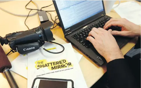  ?? FRED CHARTRAND / THE CANADIAN PRESS ?? A reporter works on his story after the release of the report The Shattered Mirror, authored by Edward Greenspon, head of the Public Policy Forum.