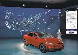  ?? Marcio Jose Sanchez Associated Press ?? FORD WILL drop the price of the base Mustang Mach-E electric SUV by $900 and the GT extended range by $5,900. Above, a 2021 model at the L.A. Auto Show.