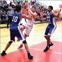  ?? LARRY GREESON / For the Calhoun Times ?? Sonoravill­e’s Bryce Waters (center) drives to the basket between two Monroe Area defenders during the first half.