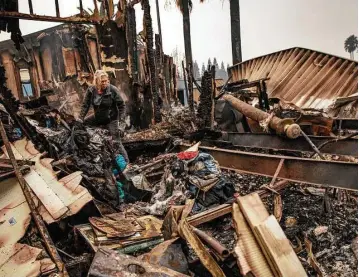  ?? Josh Haner / New York Times ?? Nancy Cook sifts through the remains of her home Tuesday at the Journey’s End Mobile Home Park after a wildfire passed through an area of Santa Rosa in northern California.