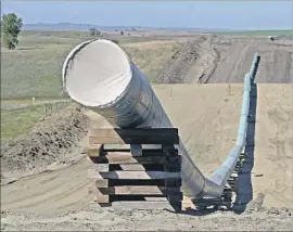  ?? Tom Stromme Bismarck Tribune ?? THE DAKOTA ACCESS pipeline, shown here under constructi­on, began transporti­ng oil this spring. A judge’s decision stopped short of ordering it shut down.