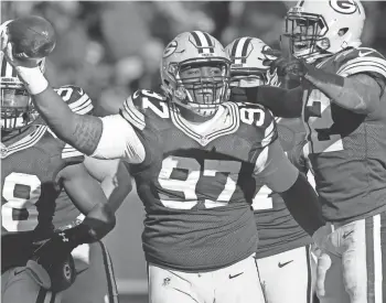  ?? MARK HOFFMAN / MILWAUKEE JOURNAL SENTINEL ?? Packers nose tackle Kenny Clark reacts after recovering a fumble on a bad snap by Vikings center Nick Easton during the second quarter. The Packers turned that into their first of two touchdowns off turnovers Saturday.