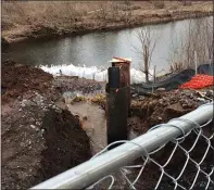  ?? EVAN BRANDT — MEDIANEWS GROUP ?? Floating booms try to contain the soil washed into the Manatawny Creek when bridge work on the King Street bridge broke a 20-inch water main Wednesday.