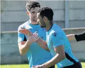  ?? Paul Watson ?? Carl Rodgers ( foreground) is congratula­ted by teammate Marcus James after putting Runcorn Town ahead against Padiham at Pavilions back in April. The midfielder has moved on to Flint Town United.