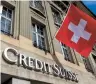  ?? Reuters-Yonhap ?? A Swiss flag is pictured above a logo of Swiss bank Credit Suisse in Bern, Switzerlan­d.