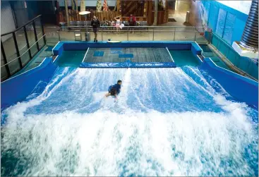  ?? RECORDER PHOTOS BY CHIEKO HARA ?? A flow rider balances on a wave Friday at Mcdermont Field House in Lindsay.