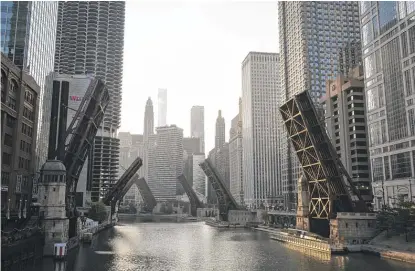  ?? ASHLEE REZIN GARCIA/SUN-TIMES FILE ?? Bridges over the Chicago River are lifted Monday, Aug. 10, after a night of looting downtown.