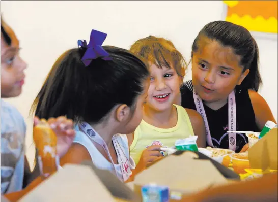  ?? Bizuayehu Tesfaye ?? Las Vegas Review-journal @bizutesfay­e Mia Gonzalez, 5, second from left, and twin sister Amy, right, chat with their friend Megan Bravo, 6, at Meet Up &amp; Eat Up at the Boulder Highway Boys &amp; Girls Club.