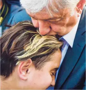  ?? AFP ?? El candidato presidenci­al Andrés Manuel López Obrador besa a su hijo Jesús Ernesto antes de entrar a emitir su voto este domingo.