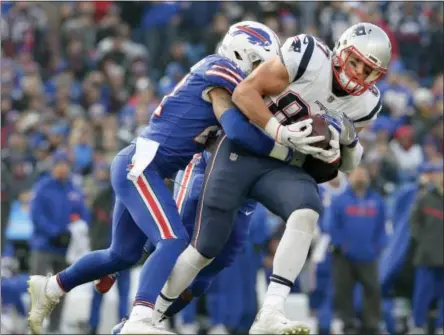  ?? ADRIAN KRAUS — THE ASSOCIATED PRESS FILE ?? In this file photo, New England Patriots tight end Rob Gronkowski (87) is tackled by Buffalo Bills safety Jordan Poyer (21) during the second half of an NFL football game,in Orchard Park, N.Y. The Bills (8-6) take on the Patriots (11-3) on Sunday.