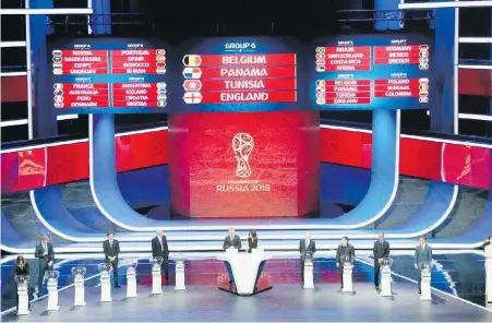  ?? IVAN SEKRETAREV, THE ASSOCIATED PRESS ?? Special guests unveil Group G during the World Cup draw at the Kremlin in Moscow on Friday. The 32-team tournament will begin June 14 with host Russia taking on Saudi Arabia.