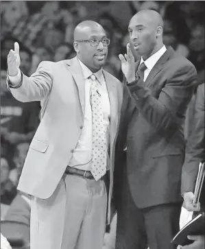  ?? By Kirby Lee, US Presswire ?? Sidelined: Lakers guard Kobe Bryant, right, with coach Mike Brown, has missed five games with an injured right shin. Bryant had the second-most playing minutes in the league before sitting out.