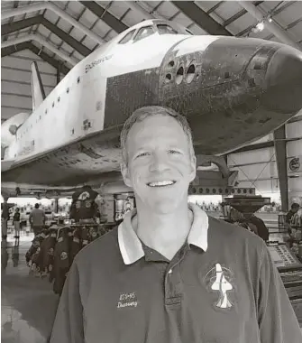  ?? Getty Images ?? Astronaut Scott Parazynski, standing in front of the Shuttle Endeavor at the California Science Center in Los Angeles, has made five trips to space.