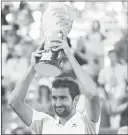  ??  ?? Marin Cilic of Croatia holds the winner's trophy after defeating Andy Murray of Great Britain in the men's singles final of the Western & Southern Open at the Lindner Family Tennis Center.