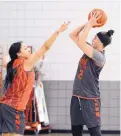  ?? JIM THOMPSON/ JOURNAL ?? UNM’s Tesha Buck shoots over Jayda Bovero during practice this week. Buck, a transfer from Green Bay, is sitting out this season.