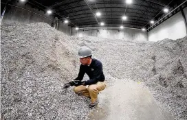  ?? AP ?? Jeremy Debenedict­is, President of Alterra Energy in Akron, stands in the storage area of shredded plastics his company receives from recycling facilities.