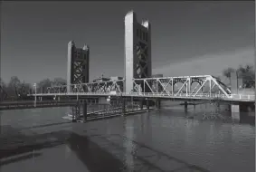  ?? GARY CORONADO/LOS ANGELES TIMES ?? The Sacramento River flows under the Tower Bridge in Sacramento on Jan. 25. Sacramento police responded to a possible bomb threat at the bridge on Tuesday.