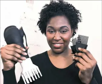  ?? Nate Guidry/Post-Gazette ?? Tamiah Bridgett, founder of Diversame, holds up a prototype hair dryer.