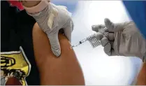  ?? KEVIN MOHATT/THE NEW YORK TIMES 2021 ?? A new study suggests that alternatin­g arms may produce a more powerful immune response. If confirmed by further study, the results could have implicatio­ns for all multidose vaccines, including childhood immunizati­ons.