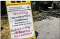  ?? BOB ANDRES / BANDRES@AJC.COM ?? Asign June 4 at Powers Island boat launch warns of Chattahooc­hee River conditions, now improving.