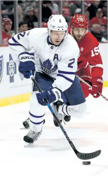  ?? GREGORY SHAMUS/GETTY ?? Toronto’s Matt Hunwick controls the puck in front of Detroit’s Riley Sheahan earlier this season. The Maple Leafs host the Red Wings Tuesday night.