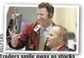  ??  ?? Traders smile away as stocks temporaril­y rebound Tuesday.