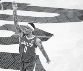  ?? Emil Lippe / Associated Press ?? Baylor guard James Akinjo gestures after making a 3-pointer against TCU. Akinjo finished with 20 points and eight assists for the top-ranked Bears.