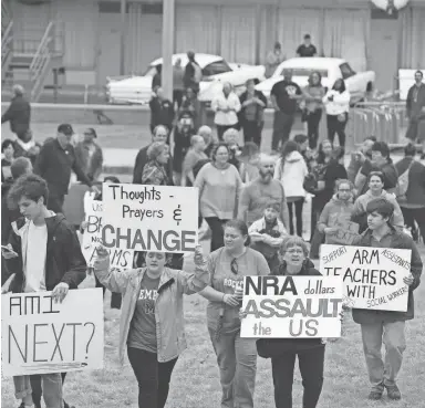  ?? PHOTOS BY ?? March for Our Lives Rally participan­ts gather in front of the Lorraine Motel in Memphis on Saturday. BRAD VEST/THE COMMERCIAL APPEAL