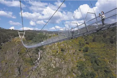  ?? Sergio Azenha / Associated Press ?? The Arouca Bridge opened Sunday in northern Portugal, about 185 miles north of Lisbon, offering a 1,700foot walk across its span above the River Paiva. Builders say it’s the world’s longest pedestrian span.