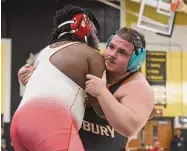  ?? Dave Stewart/Hearst Connecticu­t Media ?? Danbury’s Nuh Ajdinoski attempts to take down Fairfield Prep’s Malachi Mercer-Robinson in the heavyweigh­t final at the CIAC Class LL wrestling tournament in Trumbull on Saturday.