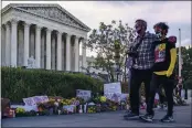  ?? J. SCOTT APPLEWHITE — THE ASSOCIATED PRESS ?? People gather at the Supreme Court in Washington on Saturday, the morning after the death of Justice Ruth Bader Ginsburg, 87.