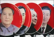  ??  ?? Souvenir plates featuring portraits of current and late Chinese leaders (right to left) Xi Jinping, Deng Xiaoping, Zhou Enlai and Mao Zedong displayed for sale at a shop next to Tiananmen Square in Beijing