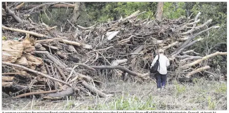  ?? DEBORAH CANNON / AMERICAN-STATESMAN ?? A woman searches for missing flflood victims Wednesday in debris near the San Marcos River offff of FM 1979 in Martindale. Overall, at least 34 people have died in Texas, Oklahoma and northern Mexico as a result of the storms across the region.