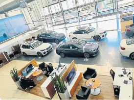  ??  ?? The new normal for car dealership­s: face masks, social distancing and more online and phone sales.