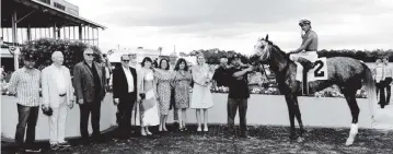  ?? Tampa Bay Downs ?? Clark Spencer, fourth from left, joins other members of the ownership group in the winner’s circle after John Velazquez rode Gouverneur Morris to victory in his 3-year-old debut at Tampa Bay Downs on Feb. 14.