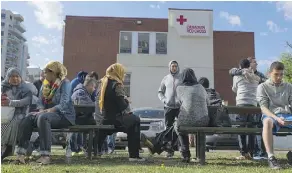  ?? SHAUGHN BUTTS ?? Evacuees from the Fort McMurray wildfire wait outside the Red Cross building in downtown Edmonton earlier this month.