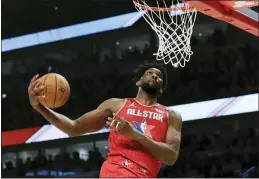  ?? NAM HUH — THE ASSOCIATED PRESS ?? Joel Embiid of the 76ers dunks during the second half Sunday in Chicago.